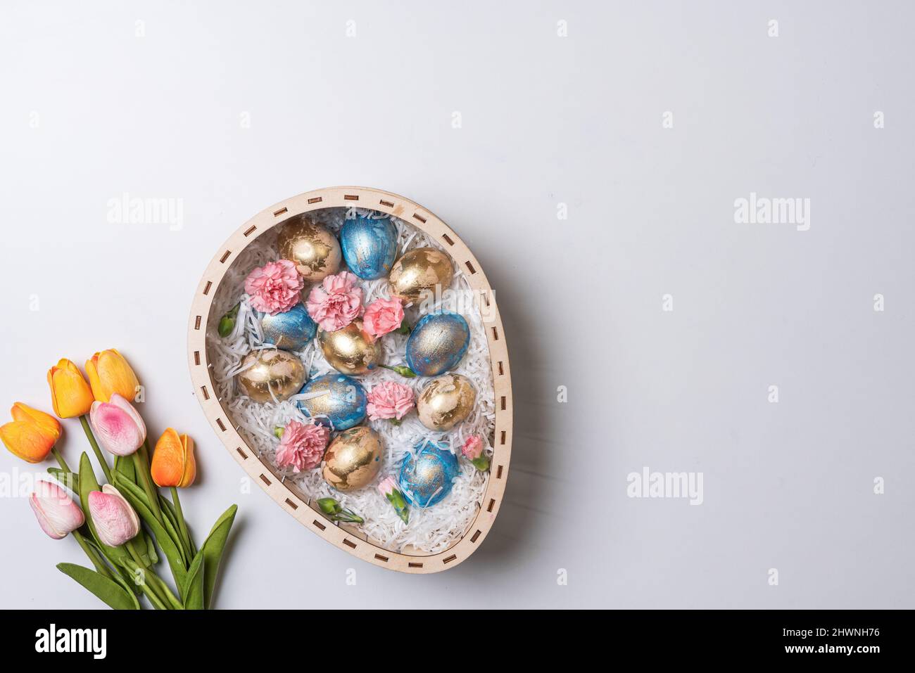 Happy easter time. Bright Easter holiday concept with spring flowers and easter eggs. Colorful Easter eggs background Stock Photo