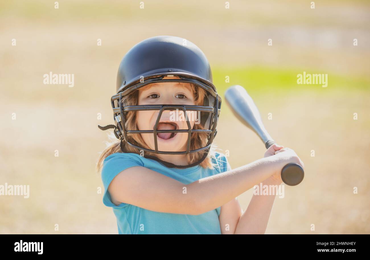 Portrait of excited amazed kid baseball player wearing helmet and hold ...