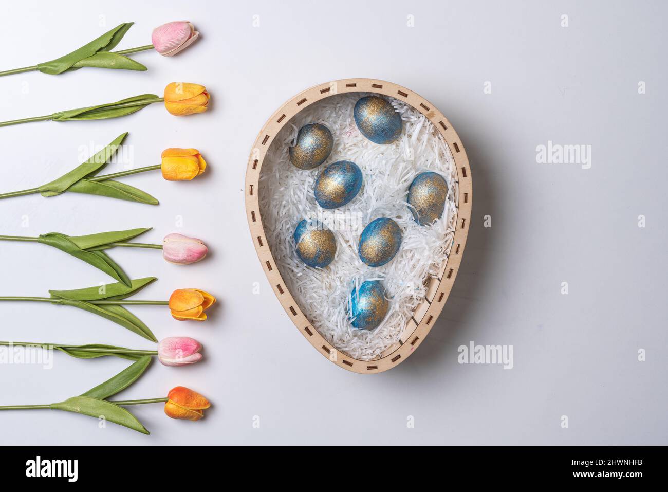 Happy easter time. Bright Easter holiday concept with spring flowers and easter eggs. Colorful Easter eggs background Stock Photo