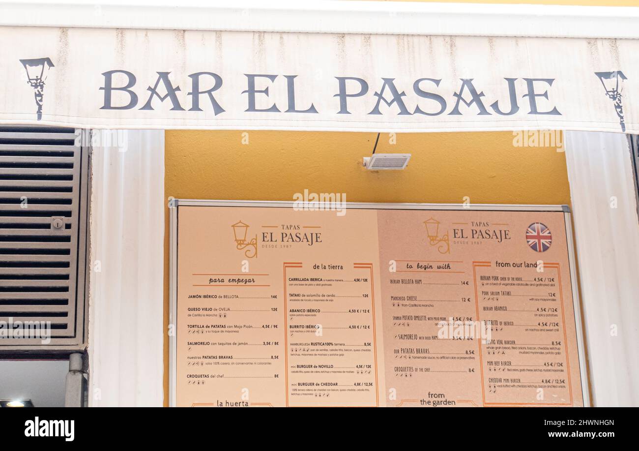 Menu of El Pasaje modern tapas bar serving meat & seafood plates, with a courtyard. Barrio de Santa Cruz, Seville, Spain Stock Photo