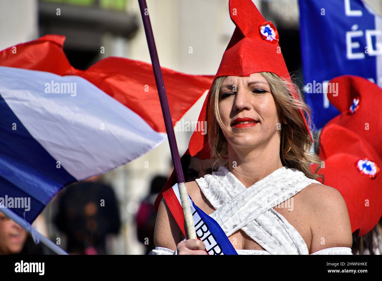 Marseille, France. 26th Feb, 2022. A woman dressed as a "Marianne" with a Phrygian  cap takes part during the demonstration. Women dressed as the "Marianne"  (symbol of freedom in France) demonstrate in