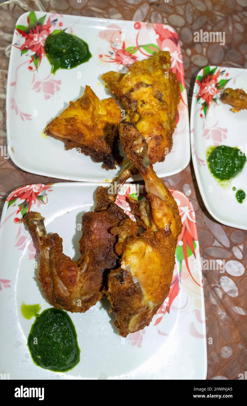 chicken tandoori with green chutney in white plate from different angle