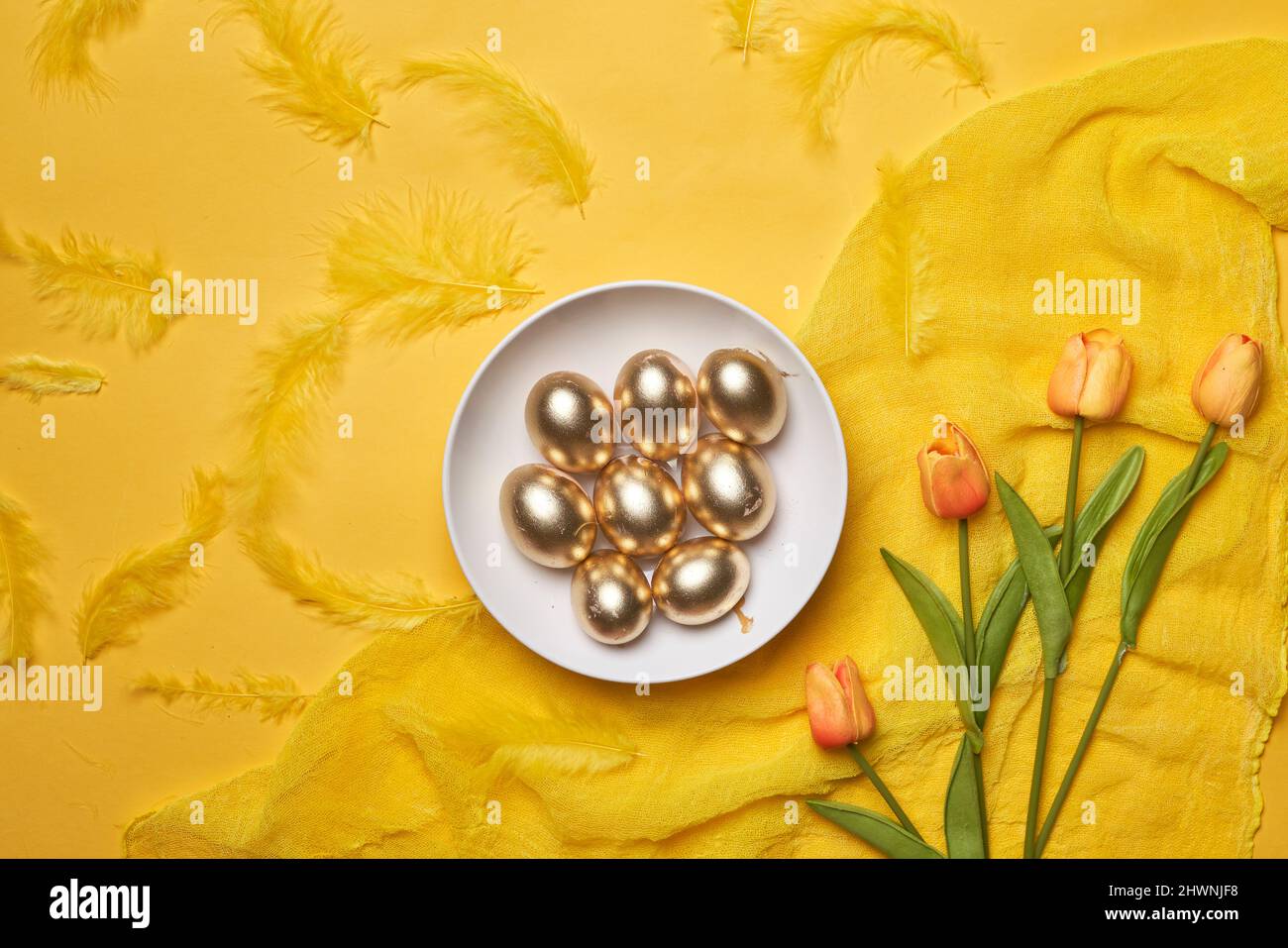 Happy easter time. Bright Easter holiday concept with spring flowers and easter eggs. Colorful Easter eggs background Stock Photo