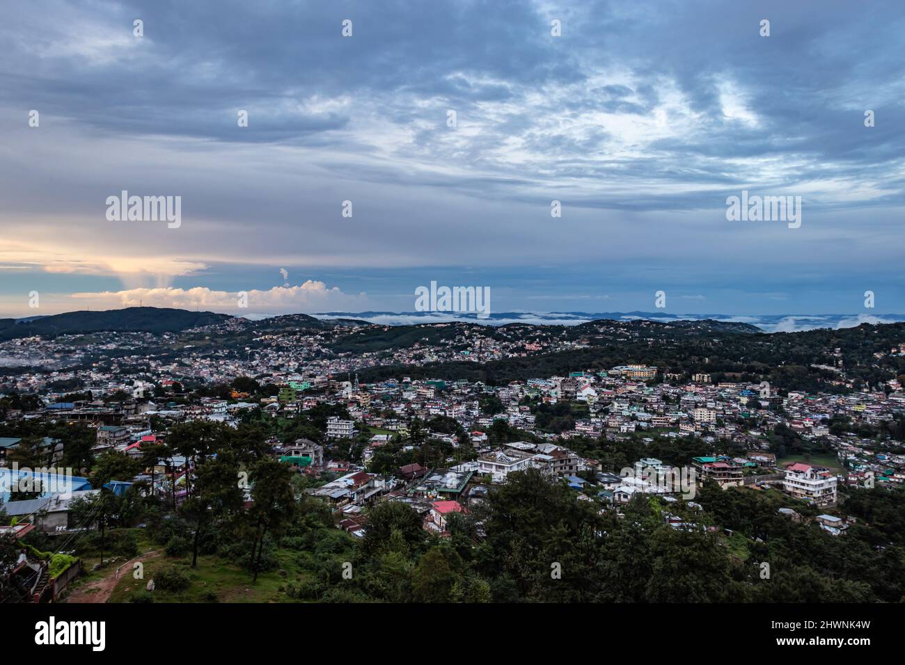 downtown city view with dramatic cloudy sky at evening from mountain ...