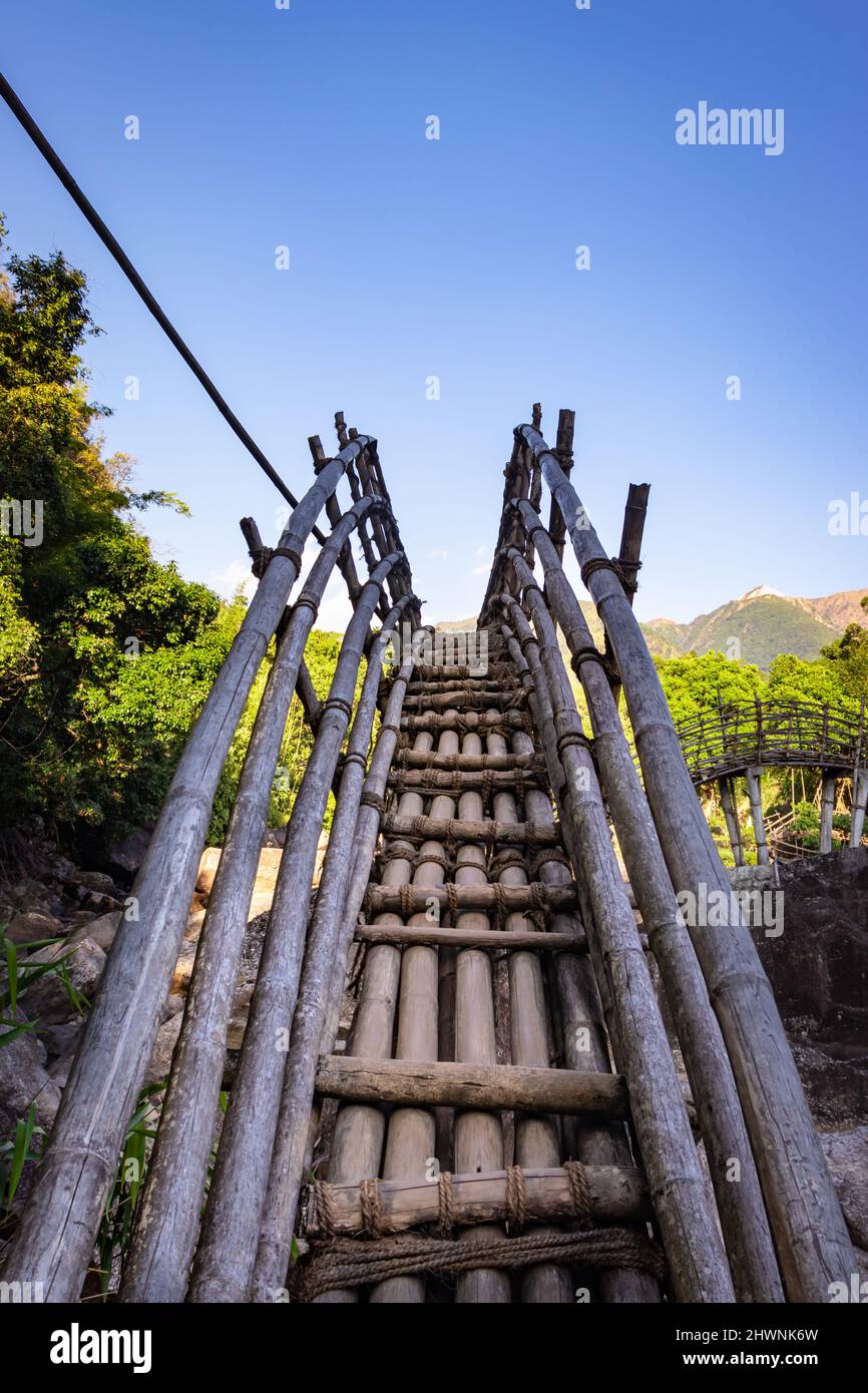 traditional bamboo bridge for crossing river at forest at morning from different angle image is taken at Mawryngkhang trek meghalaya india. Stock Photo