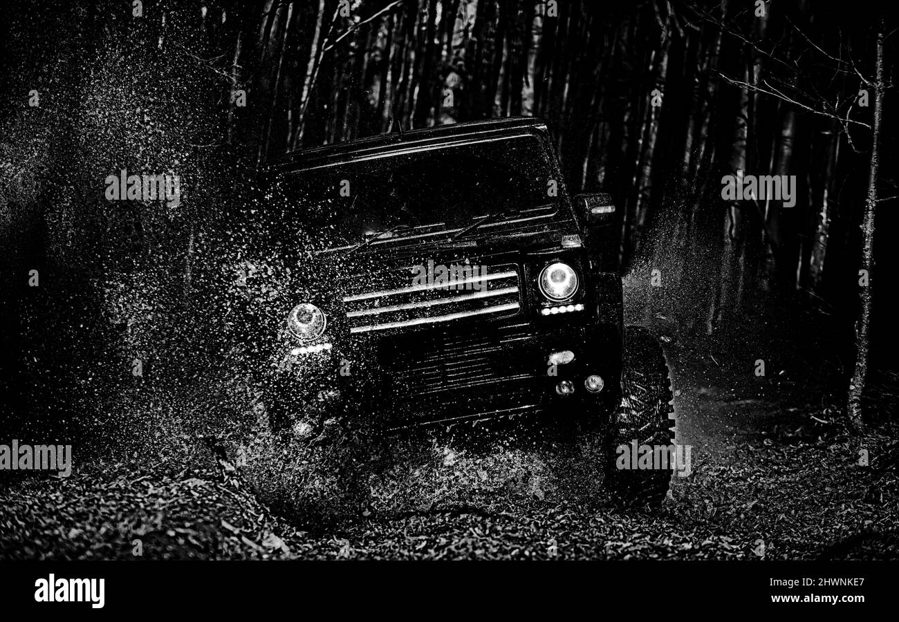 Mud and water splash in offroad racing. Offroad vehicle goes on the