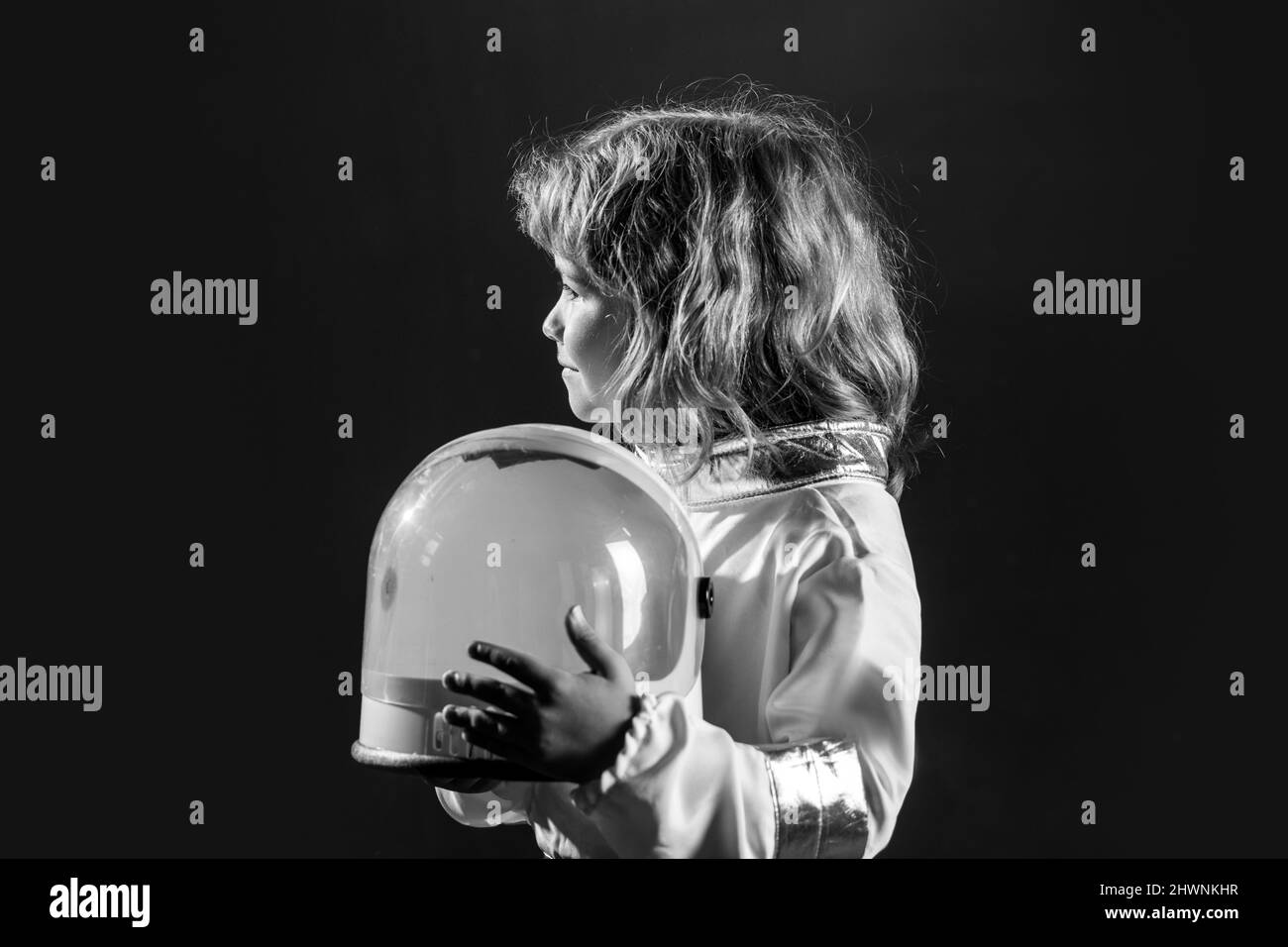 Portrait of funny kid with astronaut helmet. Cute little boy spaceman