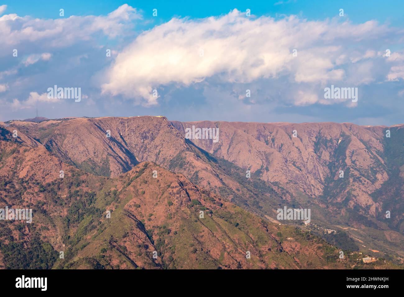 mountain range covered with bright blue sky at afternoon from different angle image is taken at shillong meghalaya india. Stock Photo