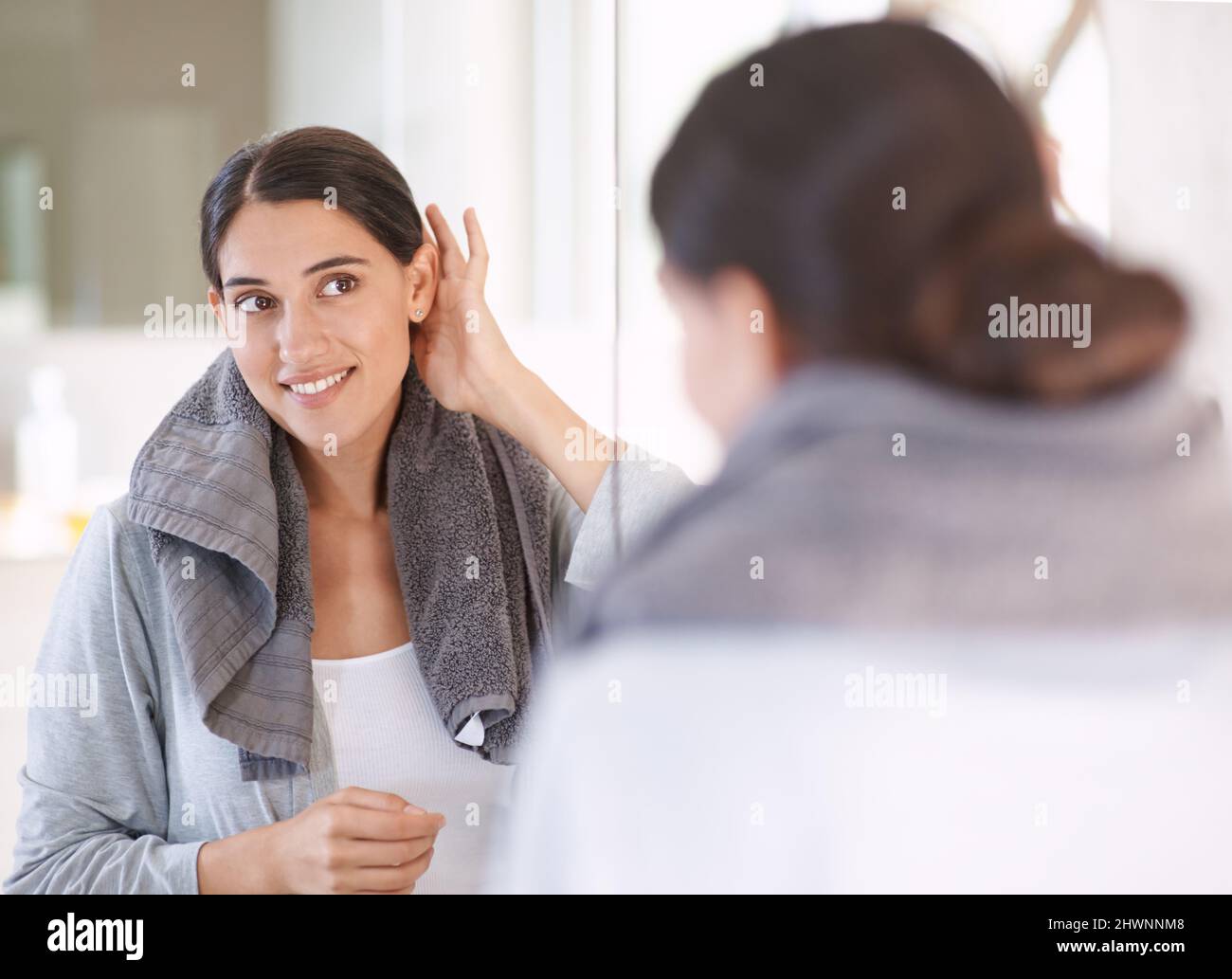 Finishing up her morning routine. A young woman drying her hair after a