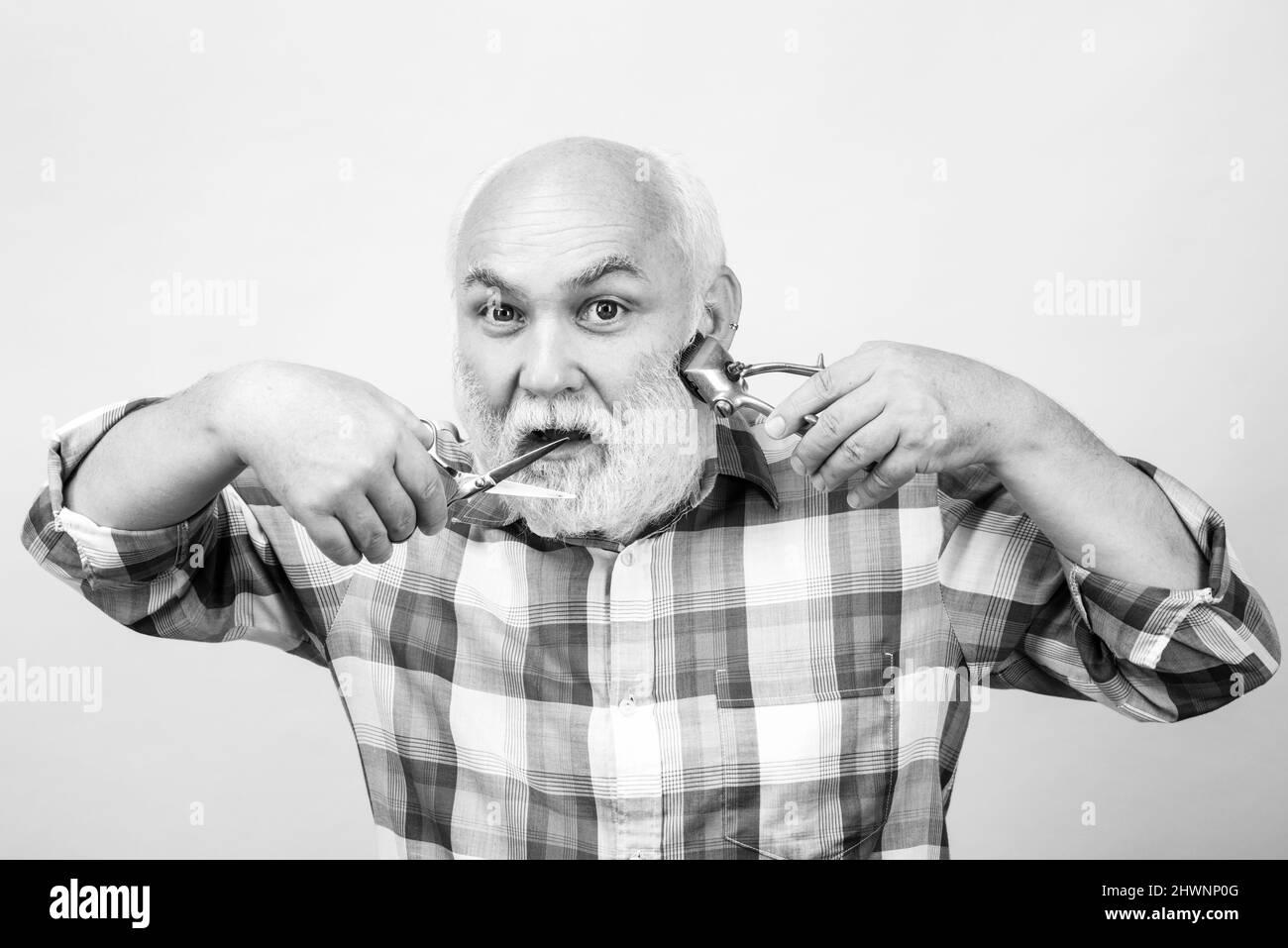 Portrait of stylish hairdresser bearded man with grey moustache beard. Bearded old man, bearded male. Stock Photo