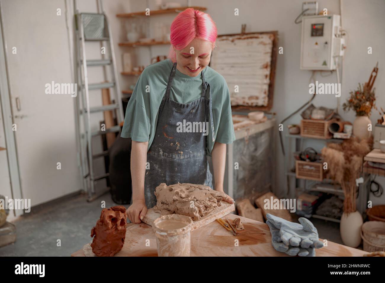 Young ceramist working with clay in workroom Stock Photo