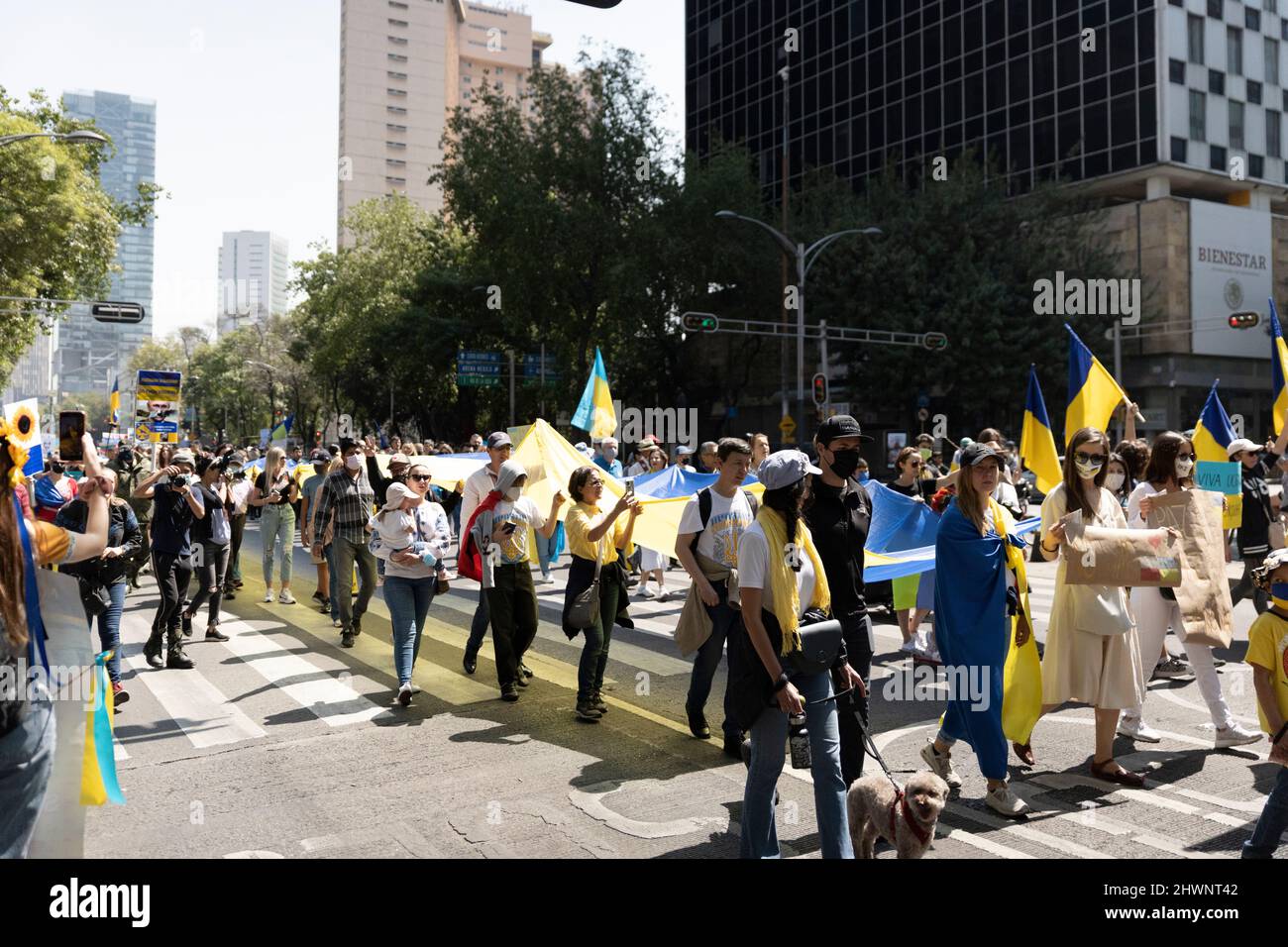 Anti-war protests in Mexico City Ukrainian supporters demonstration in Reforma Street. Flags, indignation and large group of people walking. Stock Photo