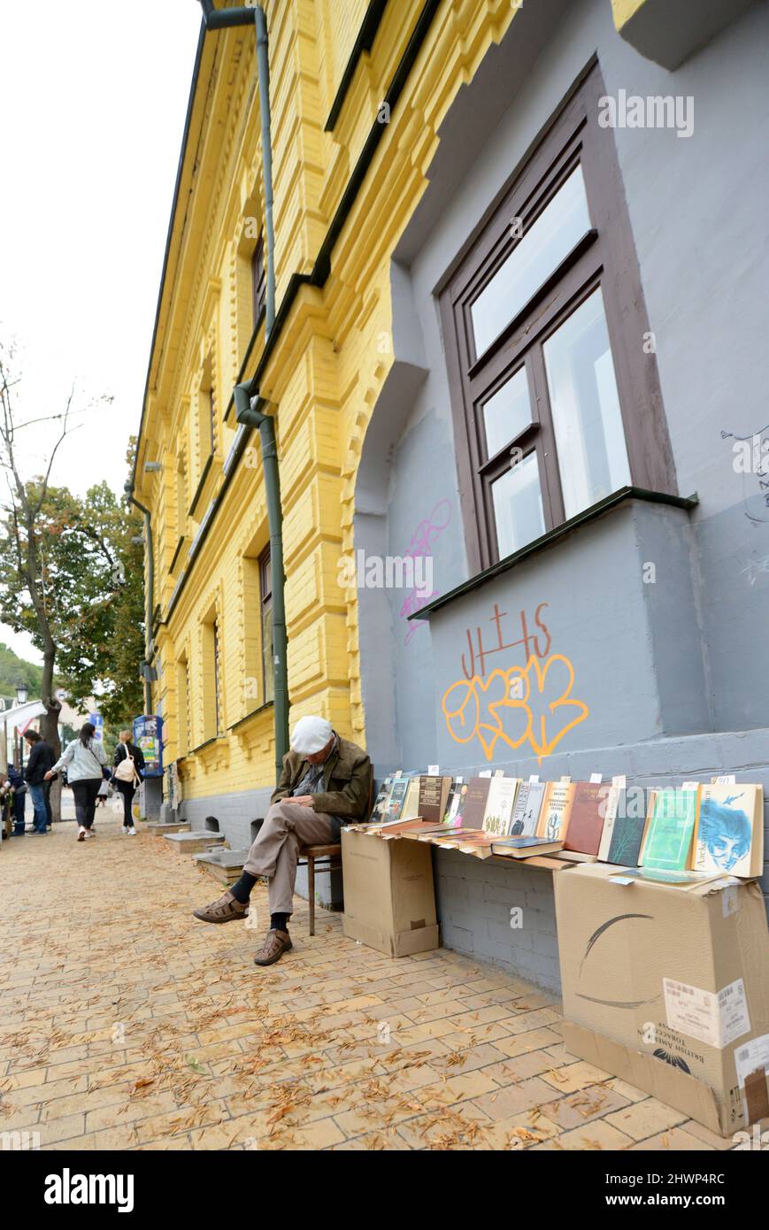 An Ukrainian man selling old books on Andriivskyi descent in Kyiv, Ukraine. Stock Photo