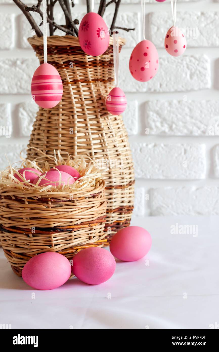 Easter composition with decorated tree branches in a wicker vase and ...