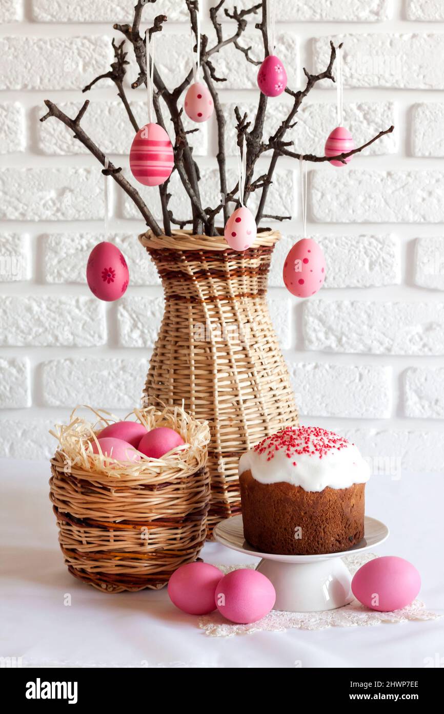 Easter composition with decorated tree branches in a wicker vase, pink ...