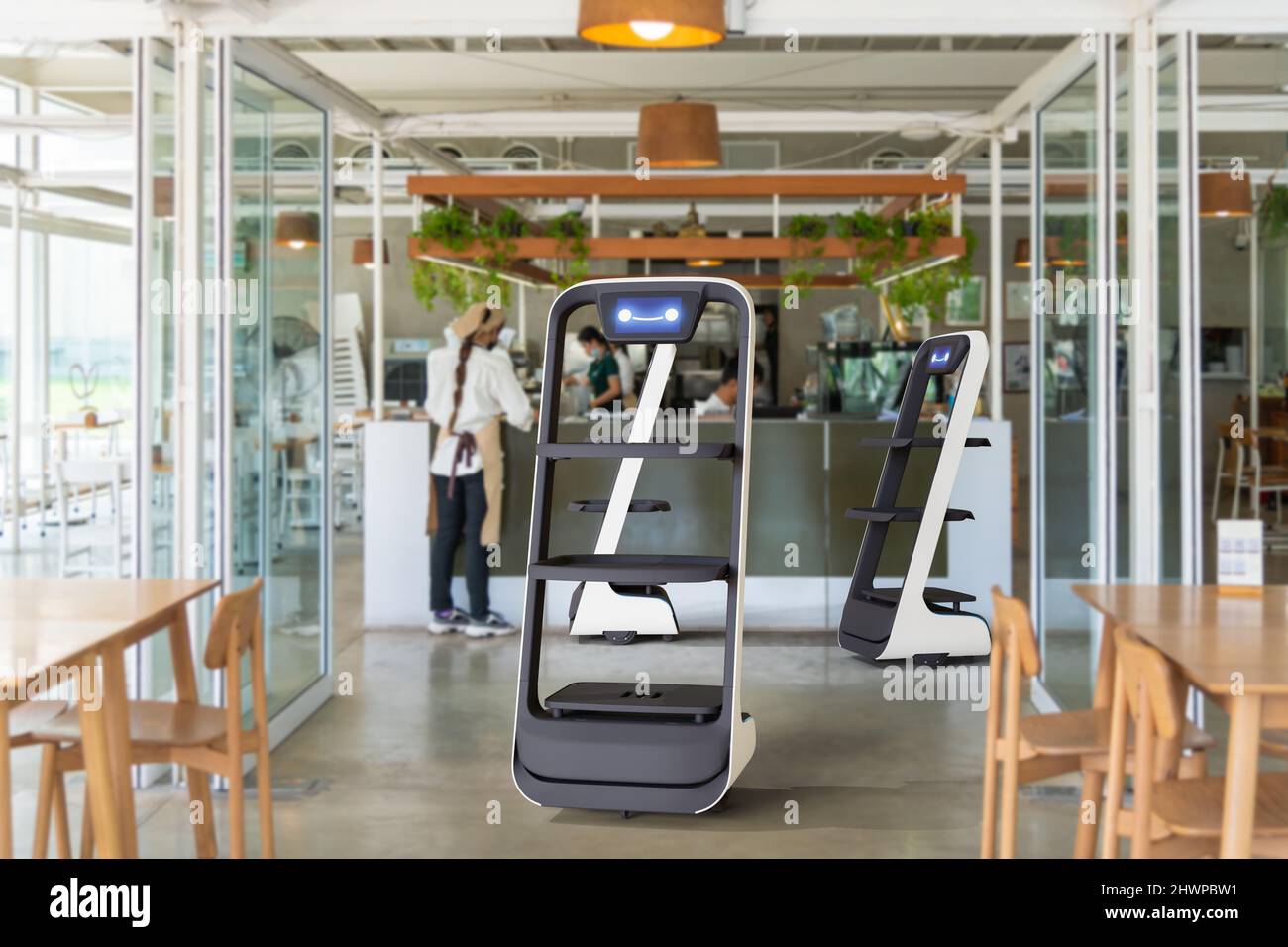 Autonomous waiter robot working in restaurant, Artificial intelligence 5G technology concept Stock Photo