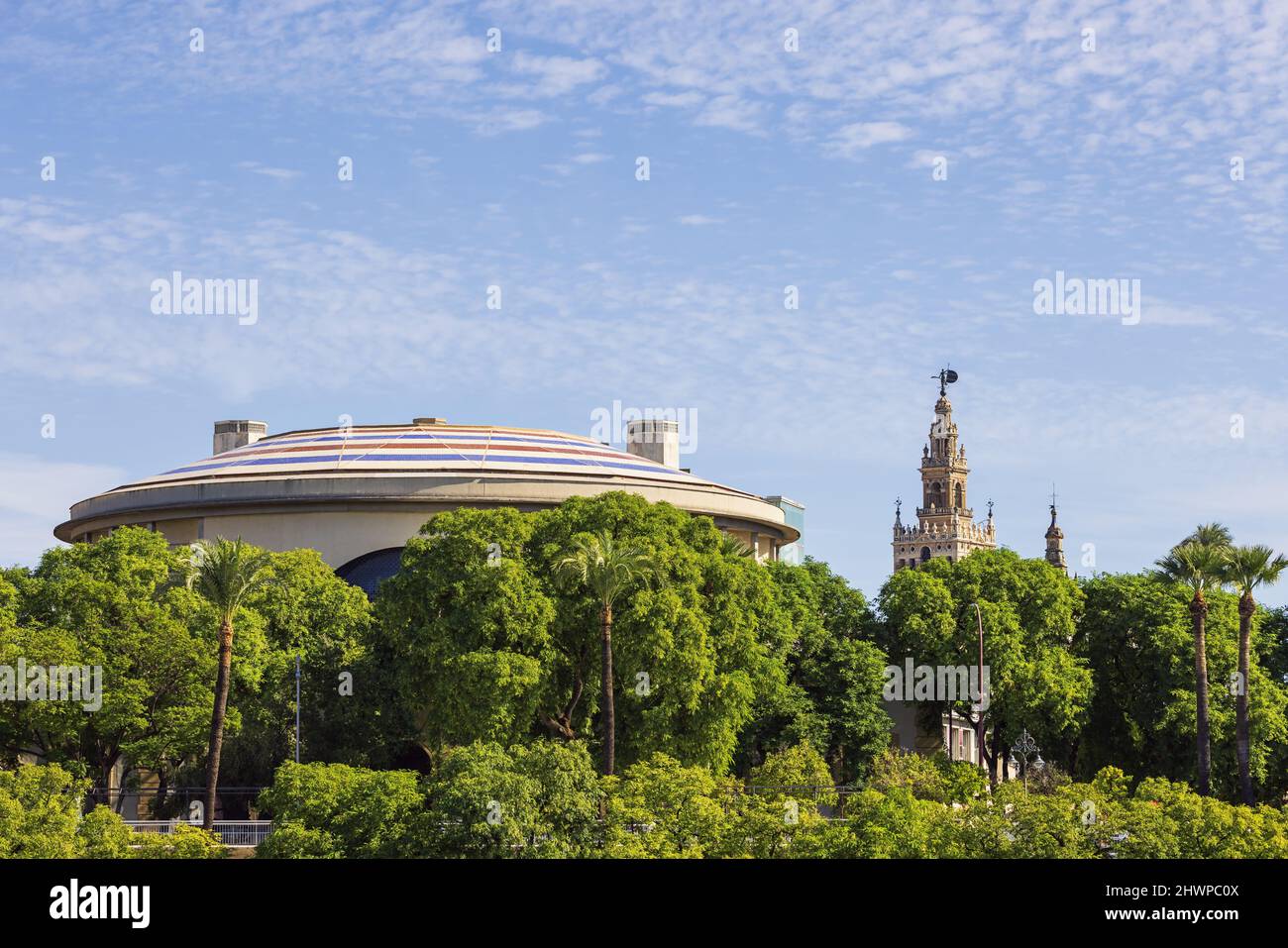 The Teatro de la Maestranza with Seville's Cathedral in the background, seen from the shore of the Guadalquivir Stock Photo