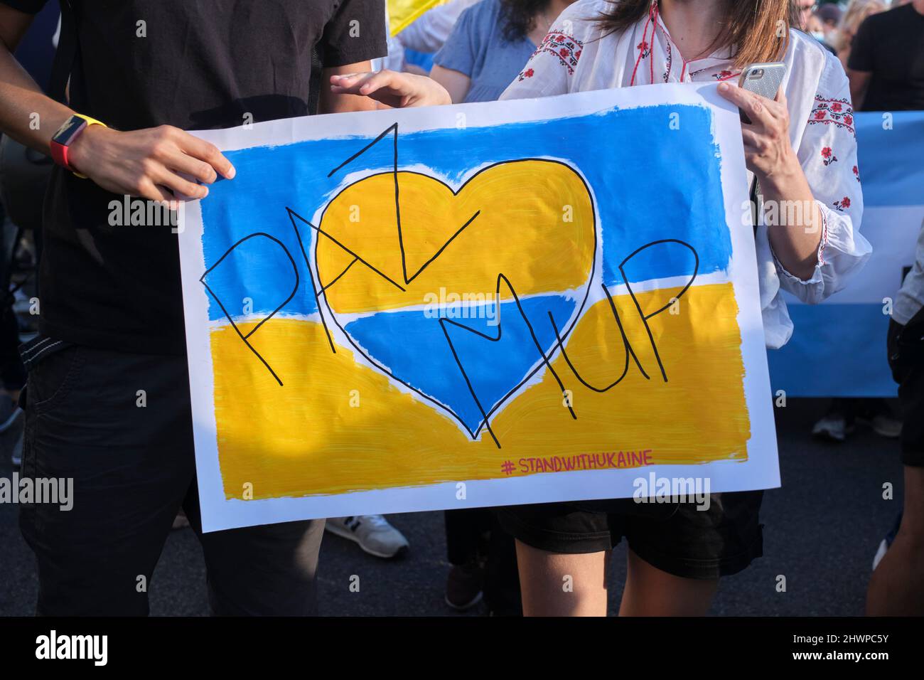 Buenos Aires, Argentina; March 6, 2022: march for peace in Ukraine, against Russian war and invasion. Ukrainian flag with a heart and the word peace w Stock Photo