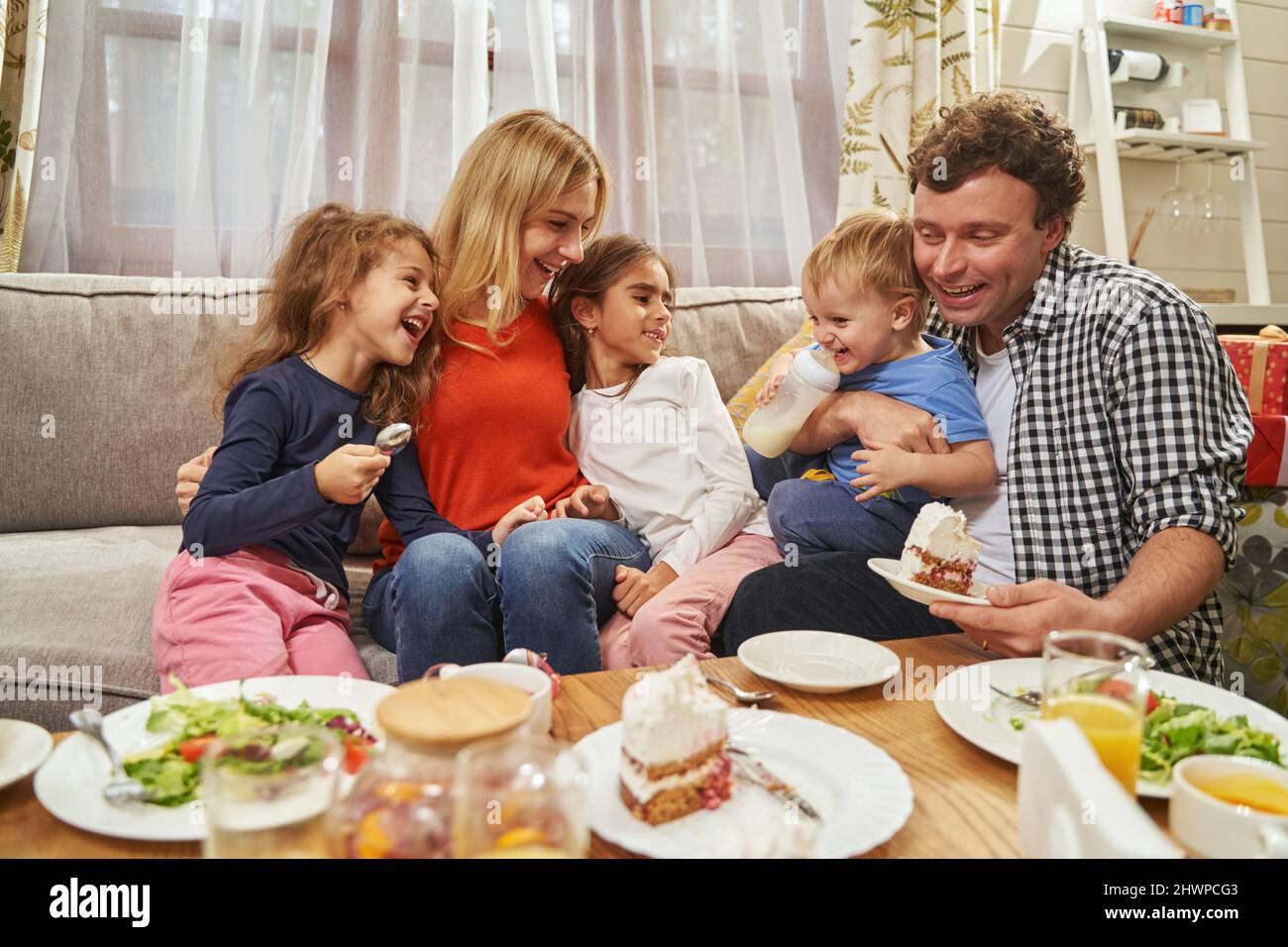 Happy parents hugging their children and smiling Stock Photo - Alamy