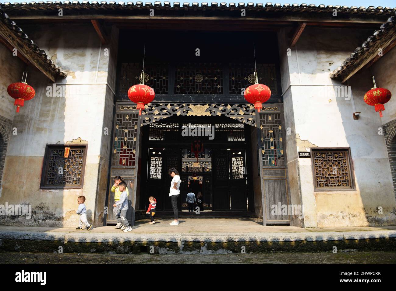 March 7, 2022, Hezhou, Hezhou, China: On March 5, in Rinchong Village, Liantang Town, Babu District, Hezhou City, friends played in a Hakka Round House...Jiang's ancestral house, located in Rinchong Village, Liantang Town, Babu District, Hezhou City, Guangxi Province, was built in the Qing Dynasty and has a history of more than 200 years. It is a typical Hakka Round House in East Guizhou. The Round House covers an area of more than 30 acres. The building is a square symmetrical structure, surrounded by a 3-meter-high wall and separated from the outside world. The layout of the buildings, halls Stock Photo