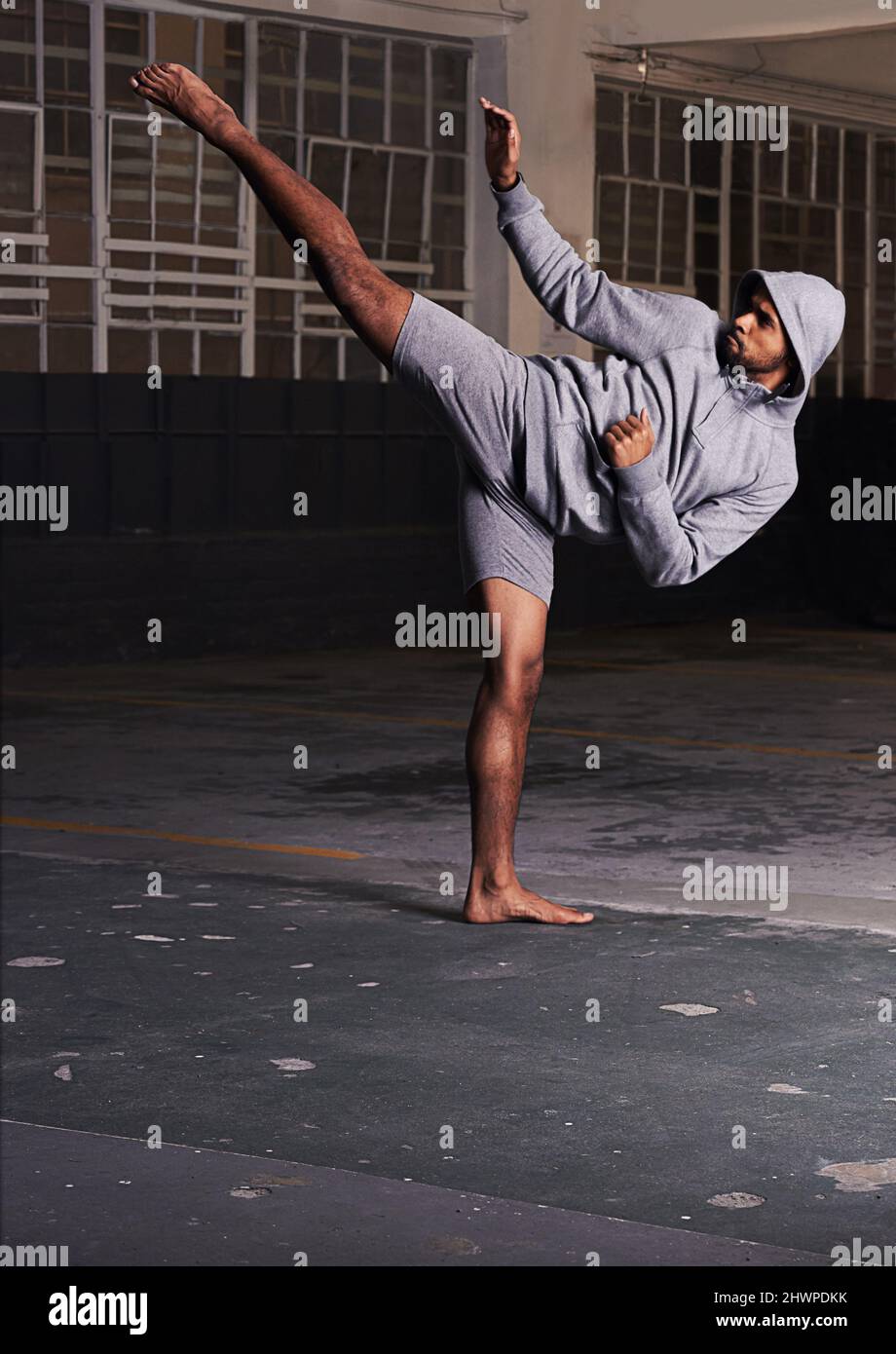 Training to be the best. Shot of a barefoot young man in activewear