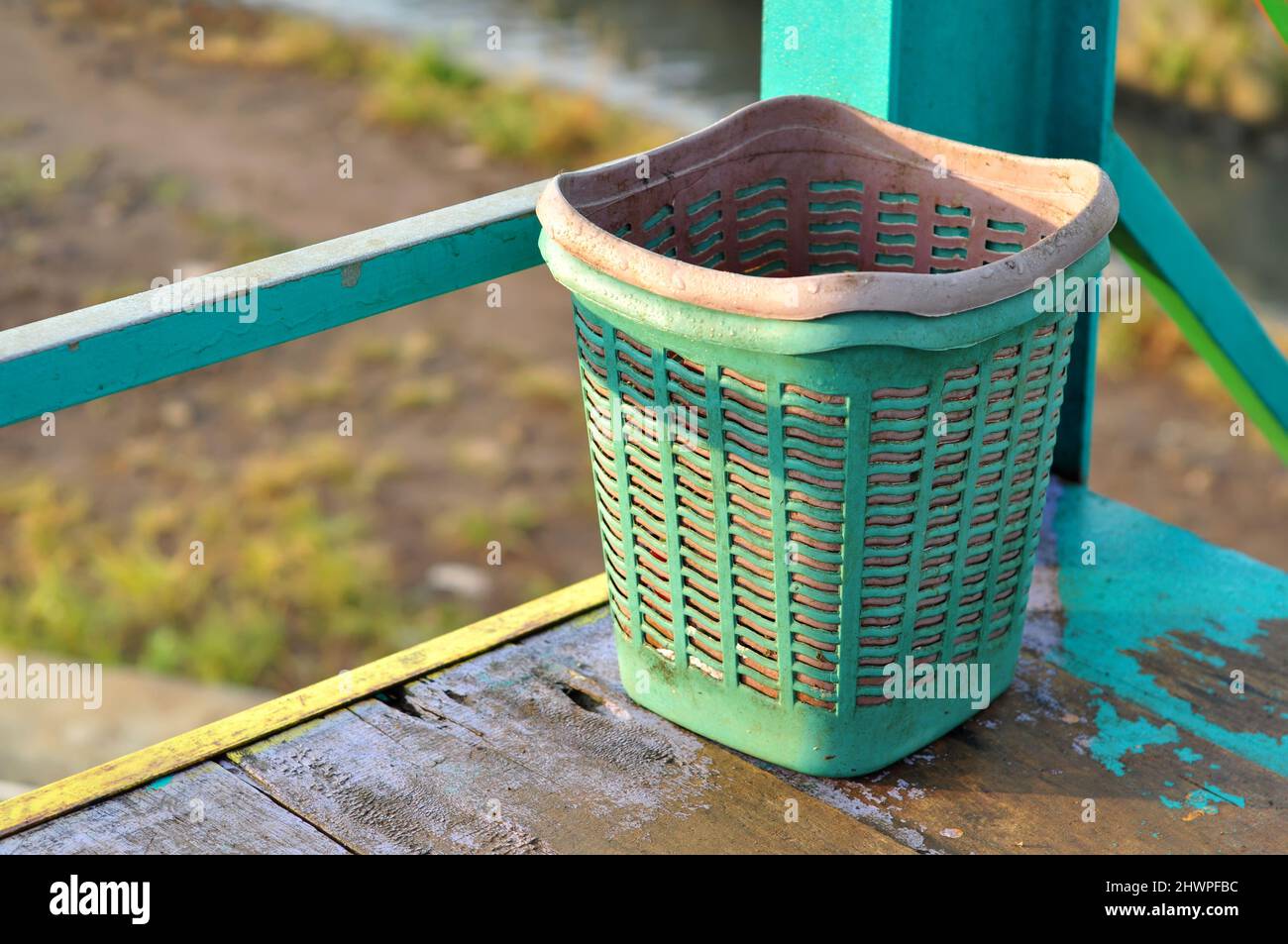Small green trash can made of plastic Stock Photo
