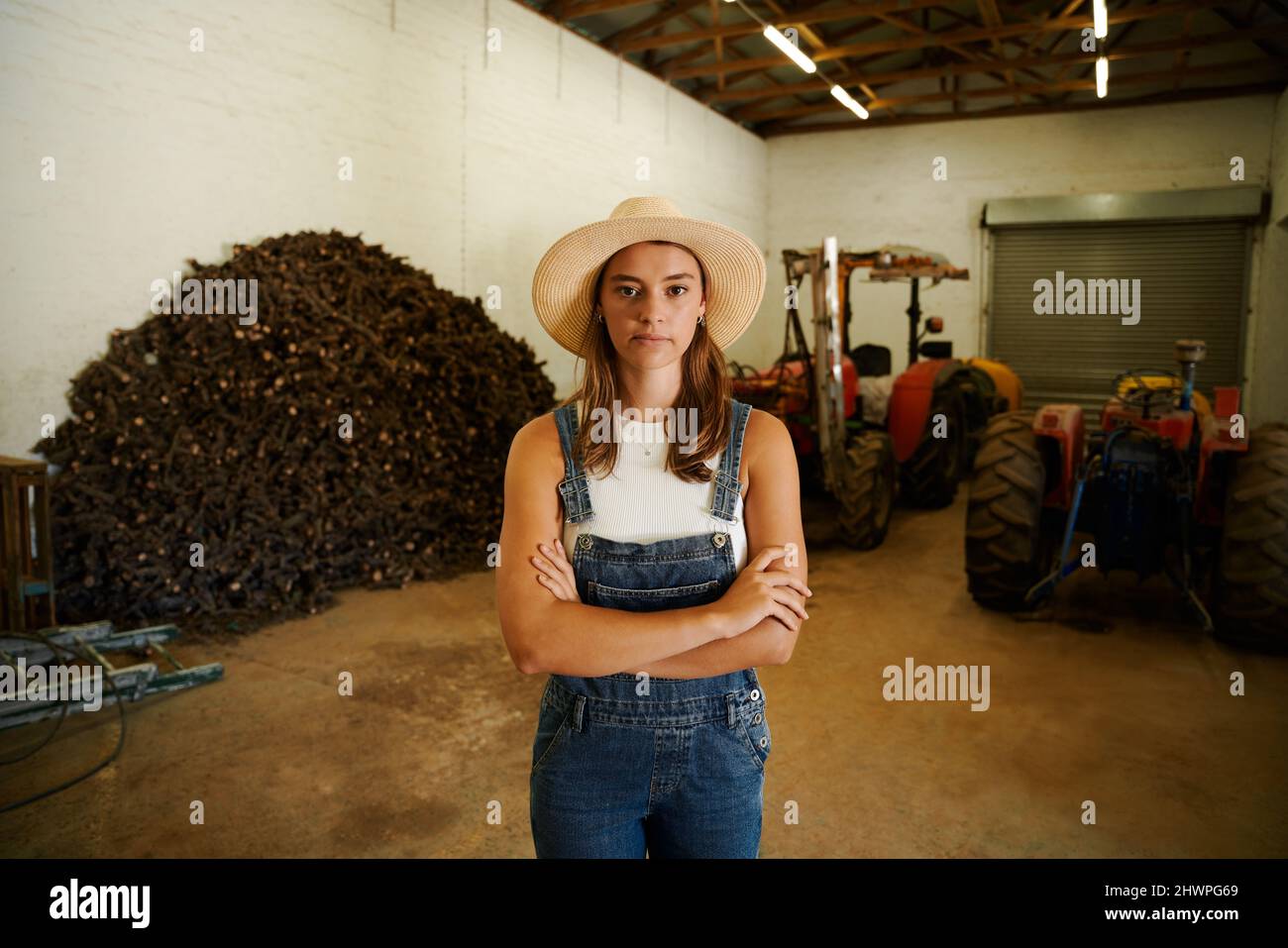 Caucasian female farmer standing in shed with arms crossed Stock Photo ...