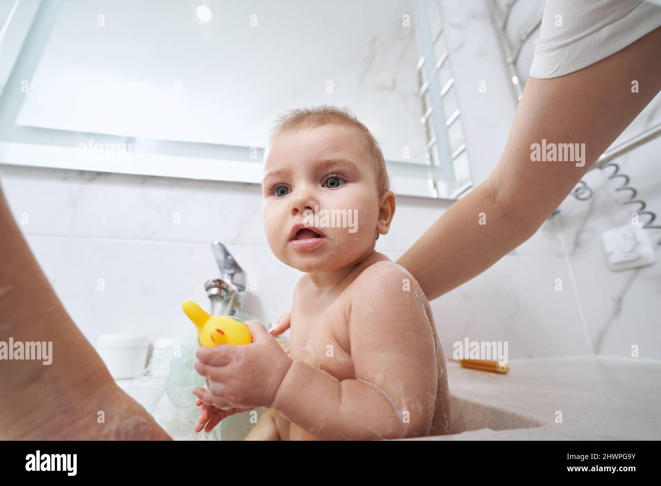 Mother bathing baby in sink hires stock photography and images Alamy