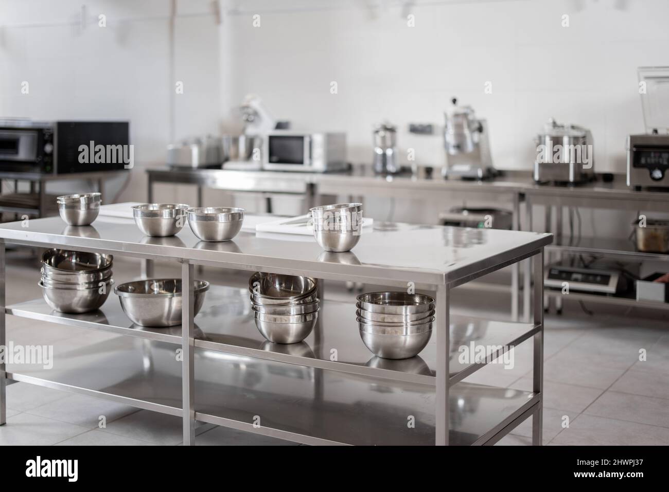 Professional restaurant kitchen with kitchen equipment and stainless steel tables. Interior with no people Stock Photo