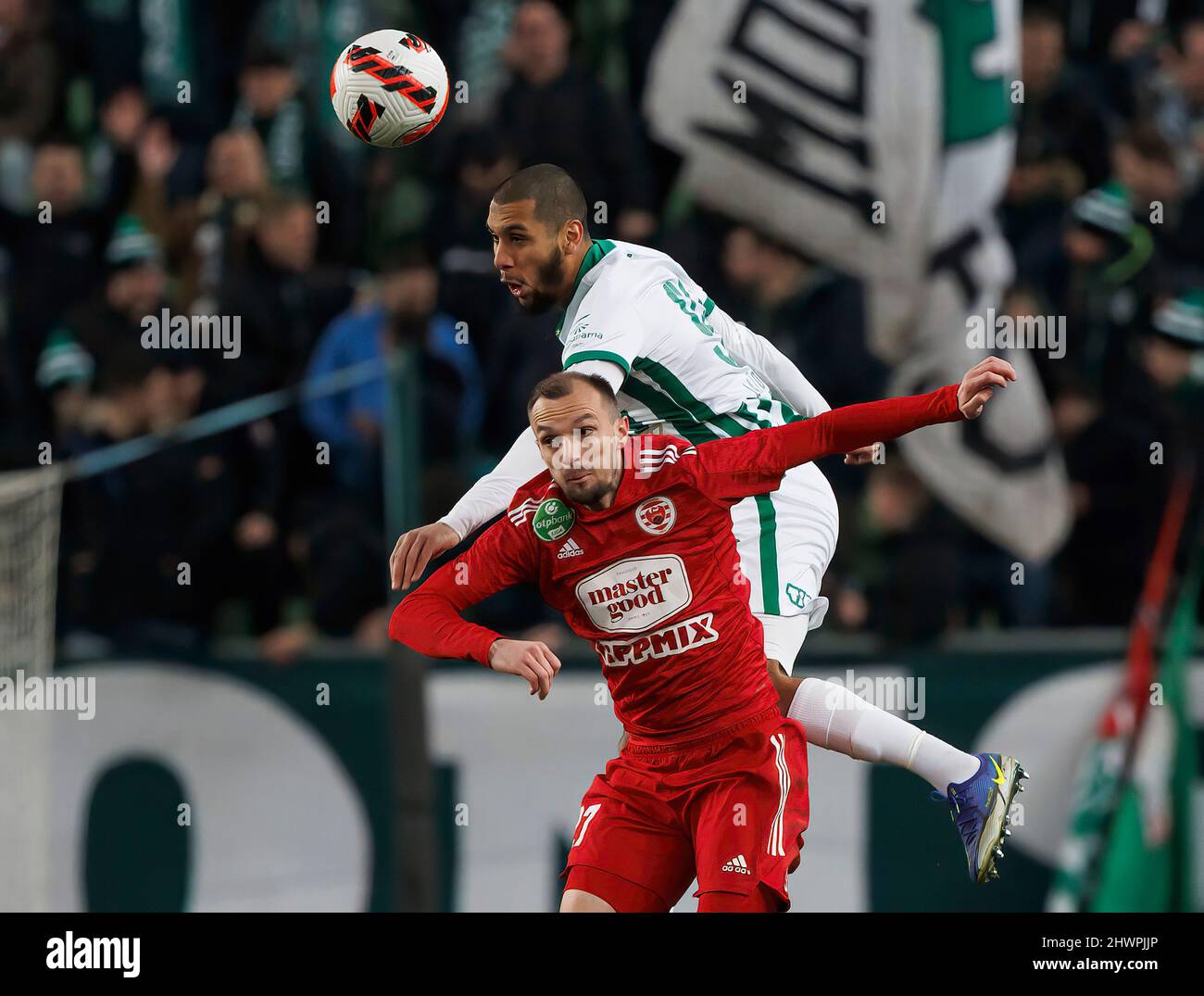 BUDAPEST, HUNGARY - MARCH 6: Jasmin Mesanovic of Kisvarda Master Good battles for the ball in the air with Aissa Laidouni of Ferencvarosi TC during the Hungarian OTP Bank Liga match between Ferencvarosi TC and Kisvarda Master Good at Groupama Arena on March 6, 2022 in Budapest, Hungary. Stock Photo