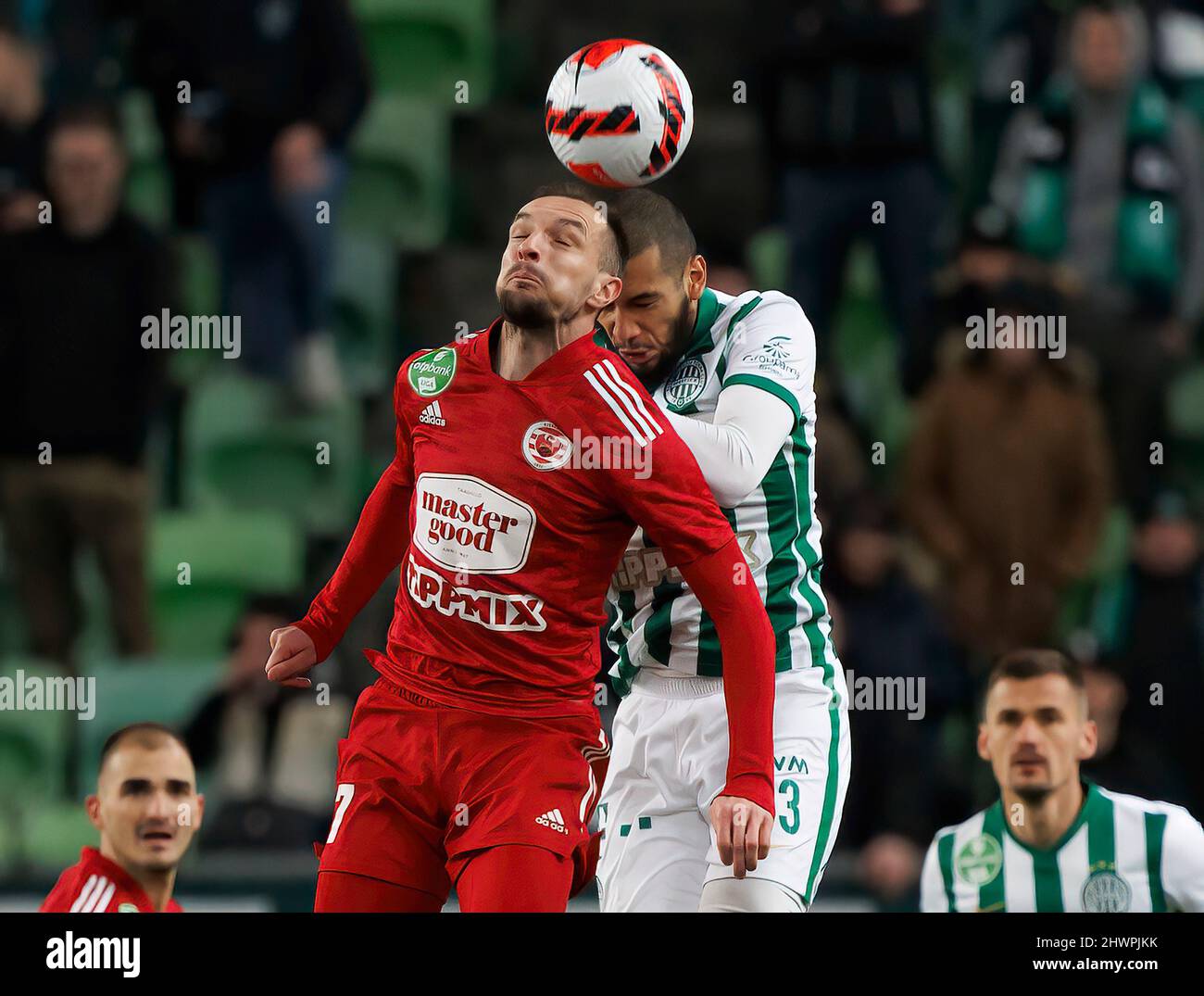 BUDAPEST, HUNGARY - MARCH 6: Jasmin Mesanovic of Kisvarda Master Good battles for the ball in the air with Aissa Laidouni of Ferencvarosi TC during the Hungarian OTP Bank Liga match between Ferencvarosi TC and Kisvarda Master Good at Groupama Arena on March 6, 2022 in Budapest, Hungary. Stock Photo