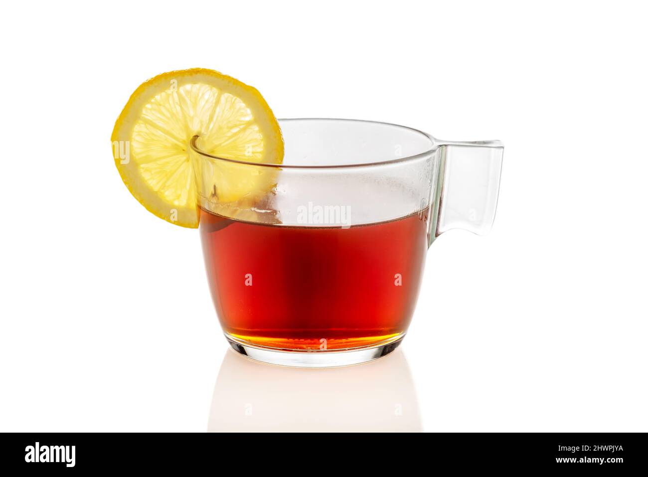 Clear glass cup of tea with lemon slice, isolated on white Stock Photo