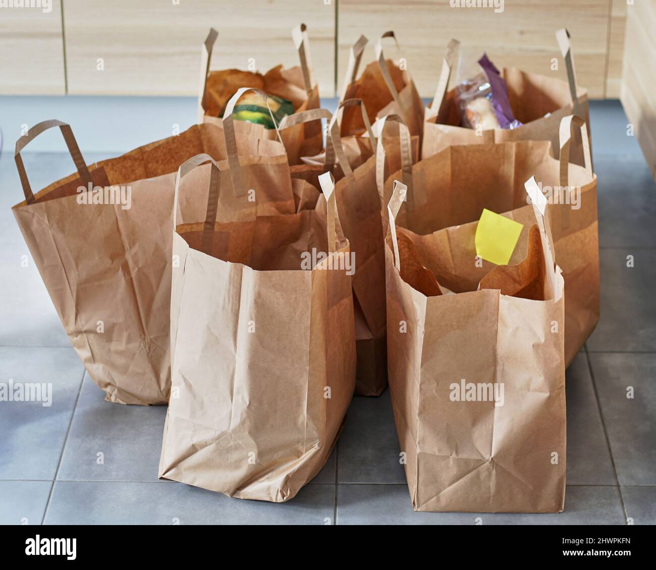 Eco friendly reusable shopping bags on a tiled floor Stock Photo Alamy
