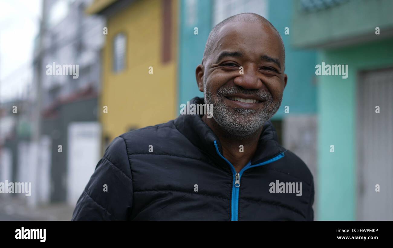 A Happy Brazilian black man laughing and smiling portrait face in urban ...
