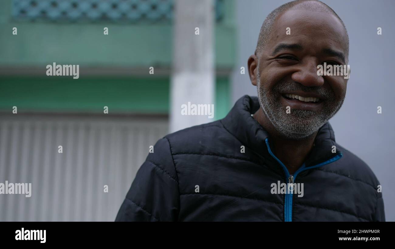 A Happy Brazilian black man laughing and smiling portrait face in urban ...