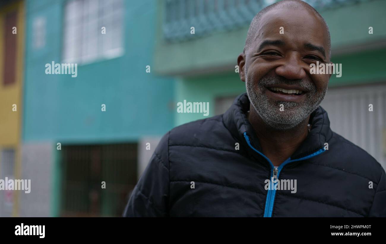 A Happy Brazilian black man laughing and smiling portrait face in urban ...