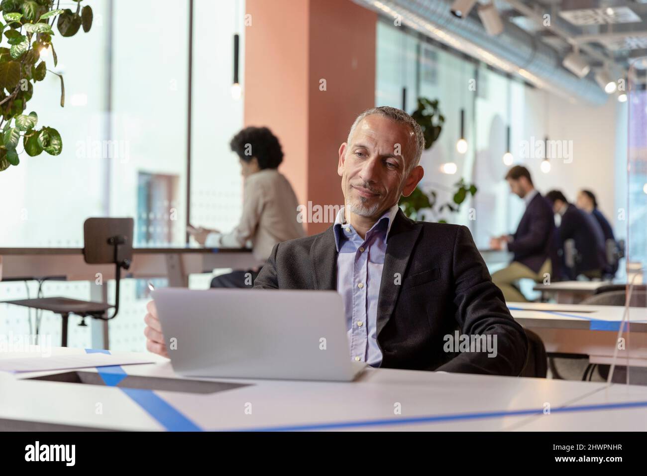 Manager working on laptop in office Stock Photo