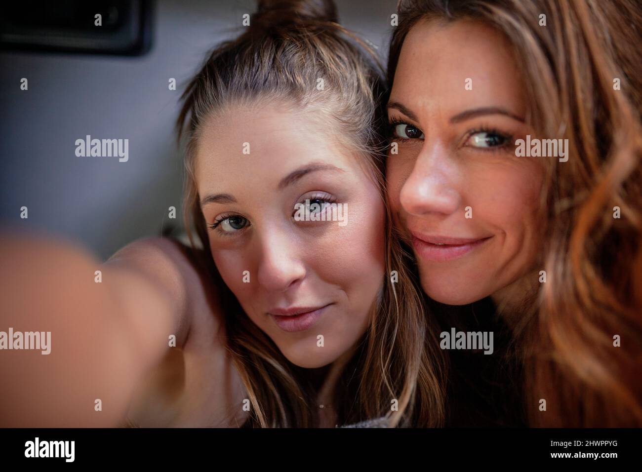 Smiling female friends taking selfie Stock Photo
