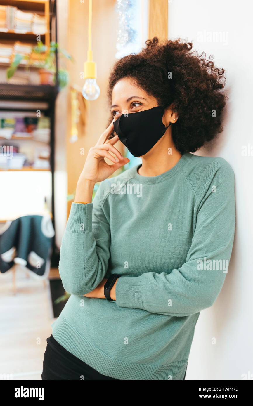 Businesswoman wearing protective face mask in office Stock Photo