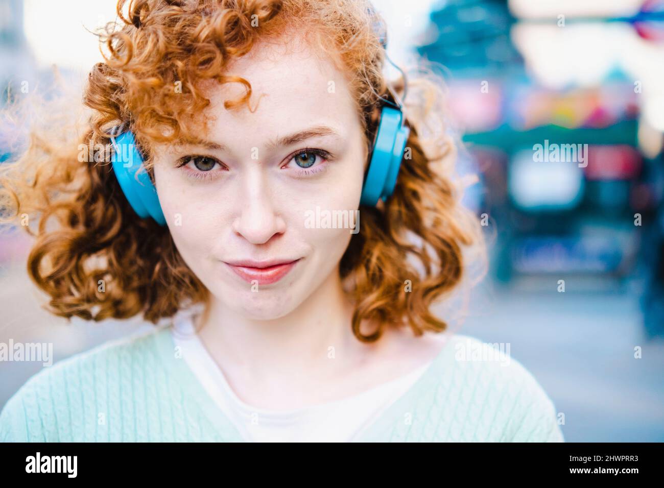 Young woman listening music through headphones Stock Photo - Alamy