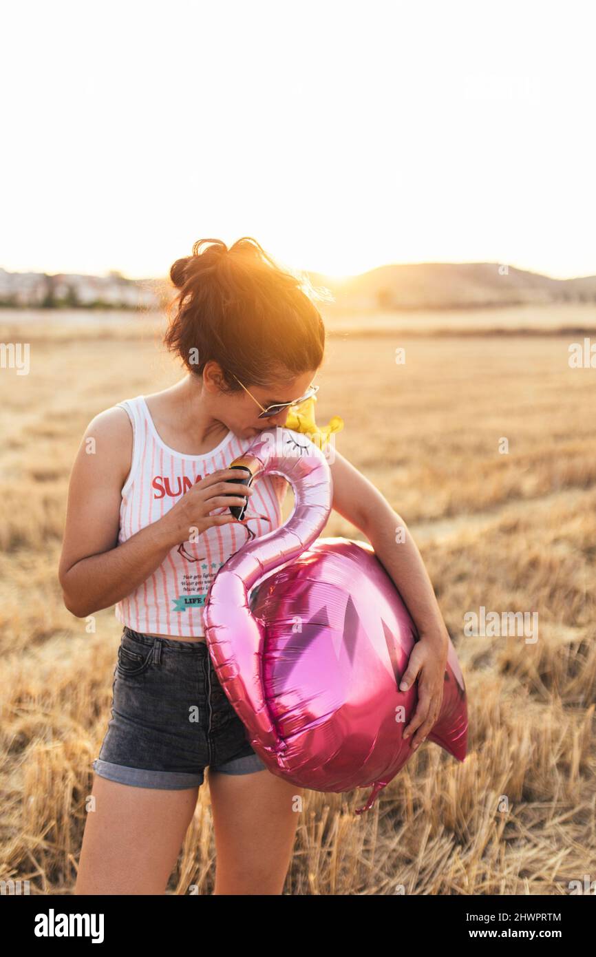 Woman kissing balloon hi-res stock photography and images - Alamy
