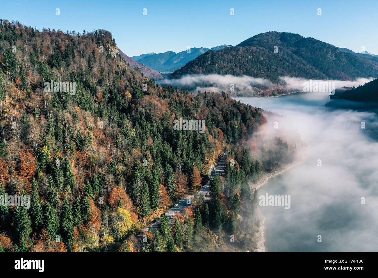 Wafts of fog over Sylvensteinsee lake, Bad Tolz, Bavaria, Germany Stock Photo