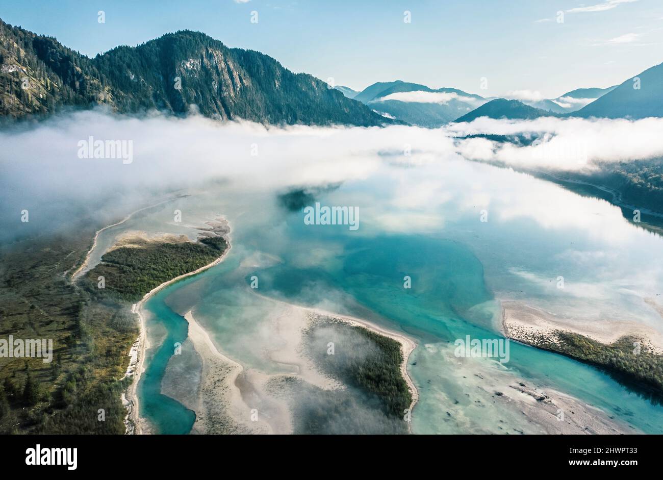 Wafts of fog over river Isar in Sylvensteinsee, Lenggries, Bavaria, Germany Stock Photo