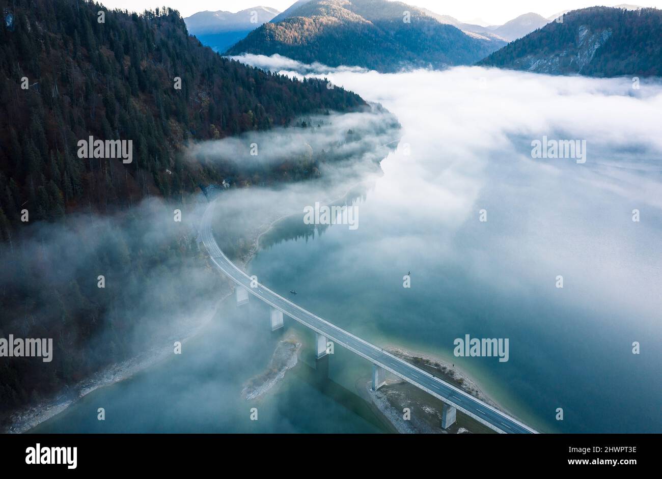 Wafts of fog over Sylvenstein dam in winter, Bad Tolz, Bavaria, Germany Stock Photo