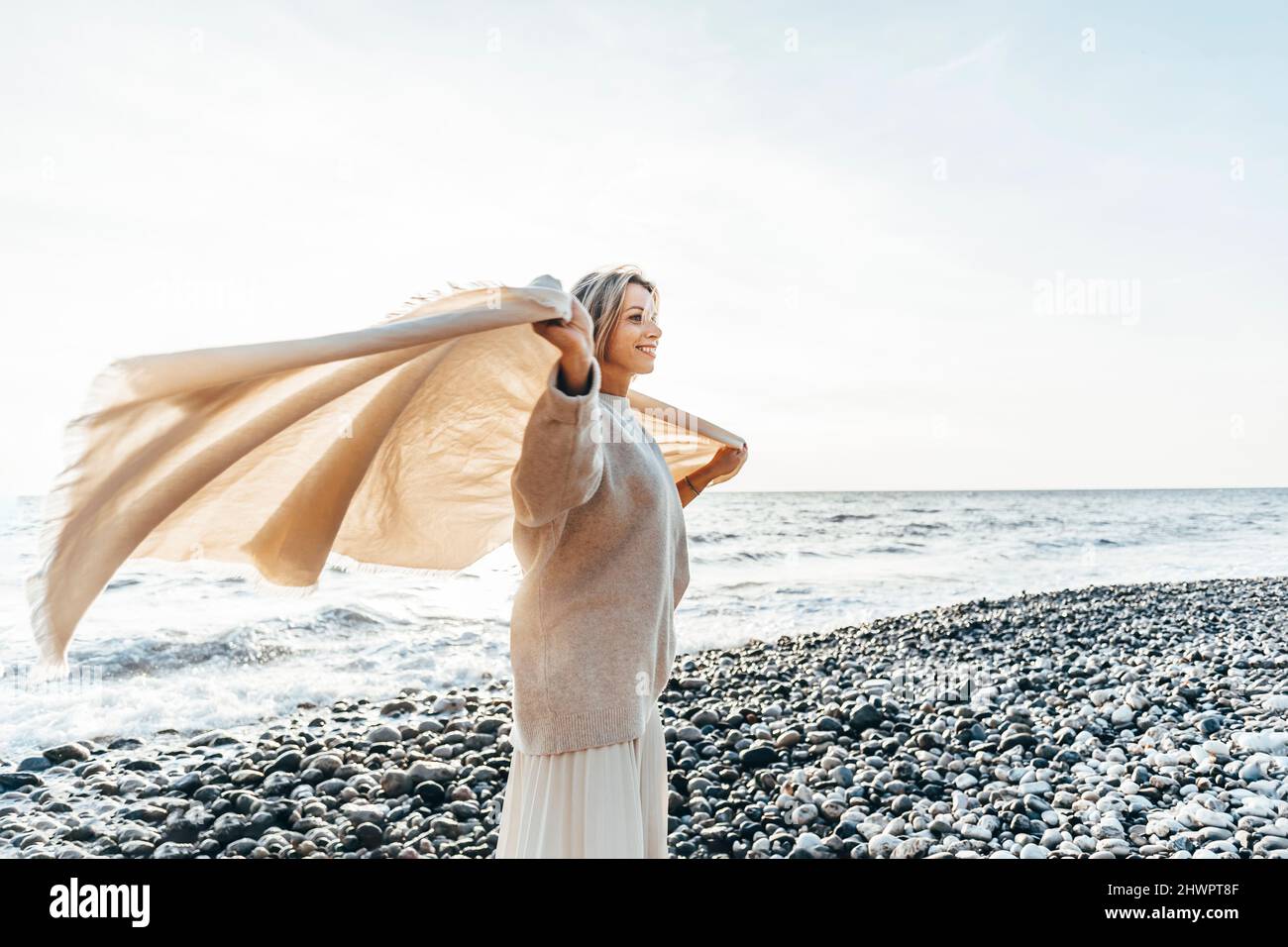 Woman stone sunset beach hi-res stock photography and images - Alamy