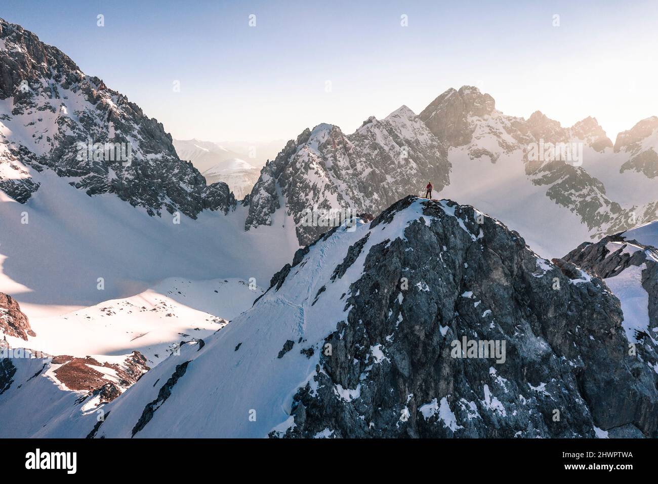 Hiker standing on snow covered mountain in winter vacation, Vorderer Tajakopf, Ehrwald, Tirol, Austria Stock Photo