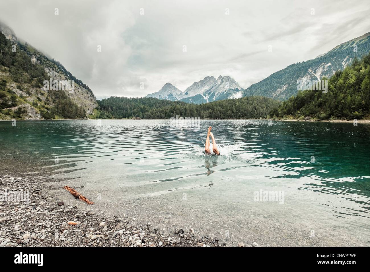 Man swiming in Blindsee lake by Mieming Range, Tirol, Austria Stock Photo