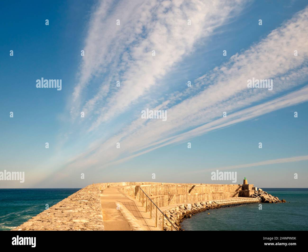 Groyne and lighthouse at Basque Coast Geopark, Basque Country, Spain Stock Photo