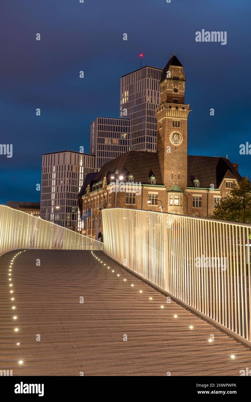 Sweden, Skane County, Malmo, Illuminated bridge at night with World Maritime University and hotels in background Stock Photo
