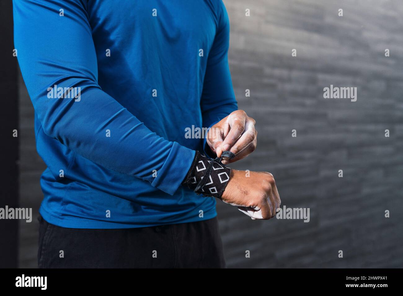 Athlete wearing wrist straps in gym Stock Photo Alamy